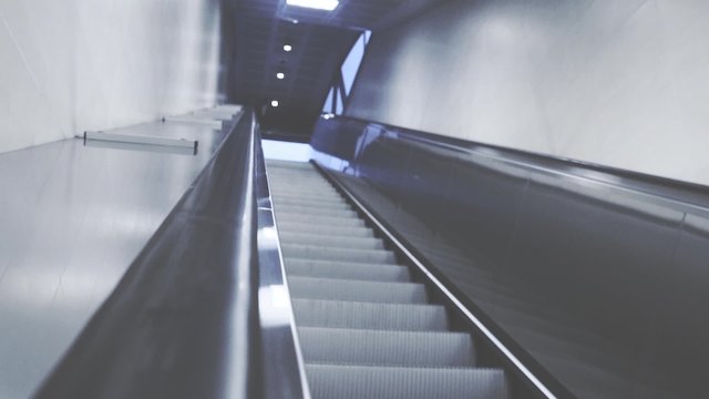 On escalators in the underground in the modern city