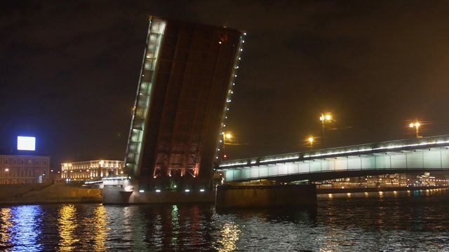 View of dissolve half bridge from boat on river. Boat float under bridge. Night