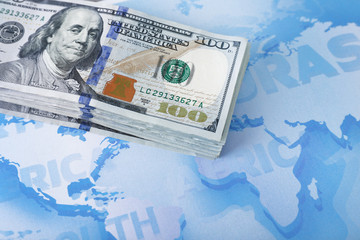 Fototapeta premium Cash on the world map background, close up