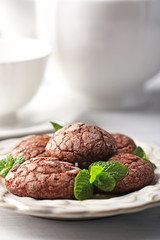 Chocolate chip cookie with mint on light background