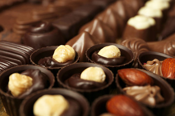 Assortment of delicious chocolate candies background, close up
