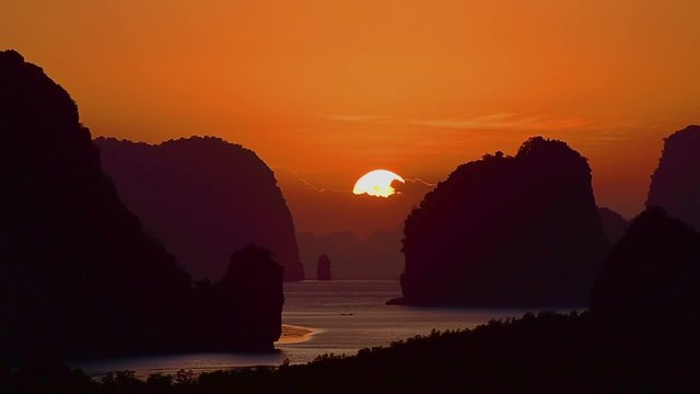 Sunrise between island mountain in morning at Phang nga bay, Thailand