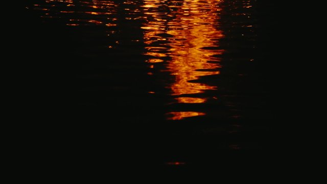 Warm fire reflections on water