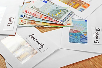 Fototapeta na wymiar Distribution of money, financial planning, euro in envelopes, on wooden table background