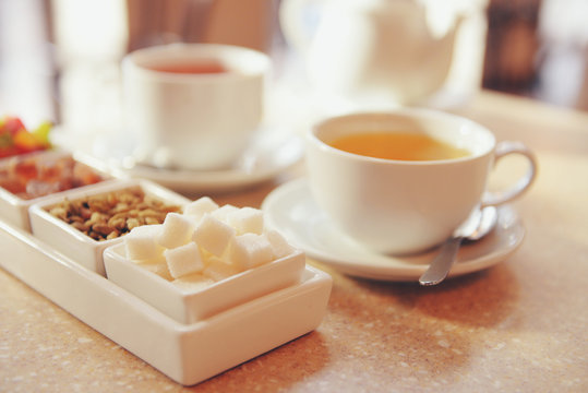 Set of candies and tea on table close up