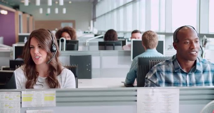 Male and female call centre workers wearing headsets