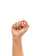 Hand holding colorful alphabet blocks "A" isolated on white back
