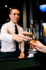 Barman giving a drink to customer