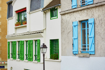 Fototapeta na wymiar Parisian buildings with green and blue window shutters
