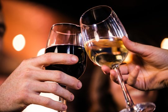 Close Up Of Friends Toasting With Wine