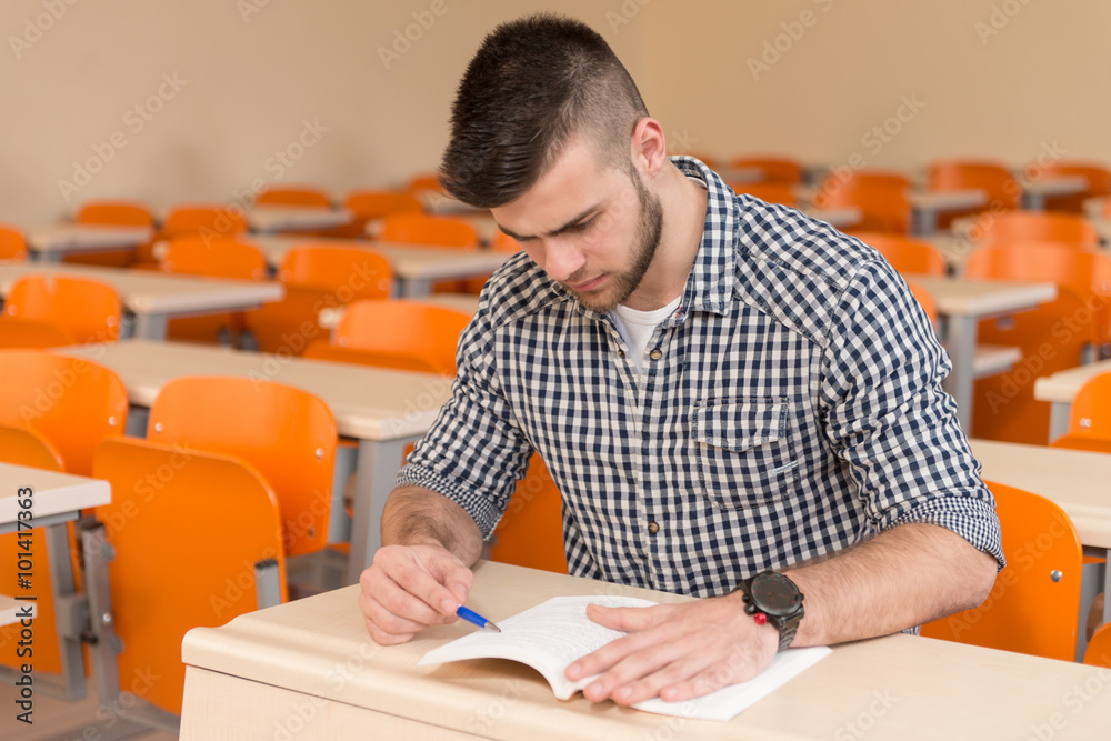 Wall mural Student With Books Sitting In Classroom