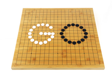 the game of go with bamboo board on white background