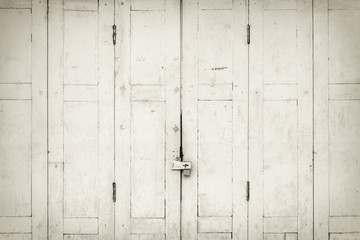 Obraz na płótnie Canvas The old grunge folding door closed in B&W.