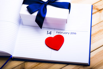 Red Wooden Heart, Gift Box And Calendar On Wooden Desk. February 14. Valentines Day Concept 