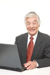 senior Japanese  businessman using laptop computer