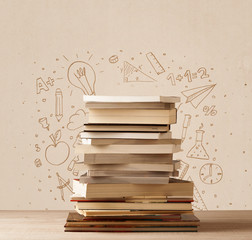 A pile of books on table with school hand drawn doodle sketches