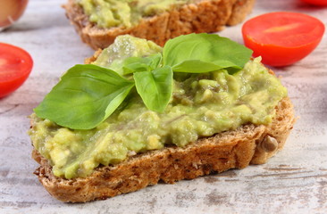 Freshly sandwiches with paste of avocado and ingredients, healthy food and nutrition