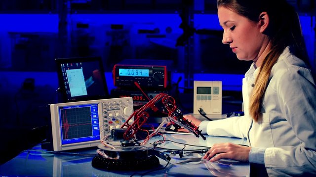 cientist adjusts the robot arm