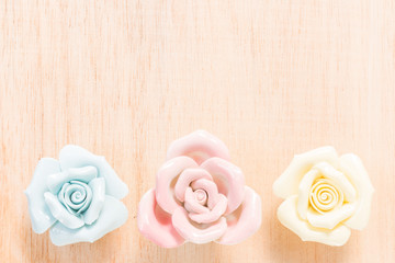 Closeup Pastel Rose (Ceramic ) on wooden background