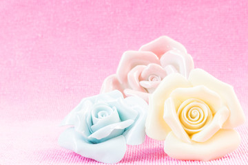 Obraz na płótnie Canvas Pastel Rose (Ceramic ) on pink fabic background