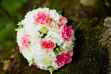 Wedding bouquet on the moss at tree