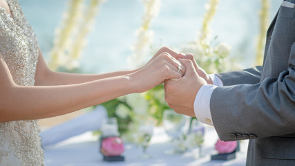 Man & Woman holding hands in wedding ceremony. Hand in hand.