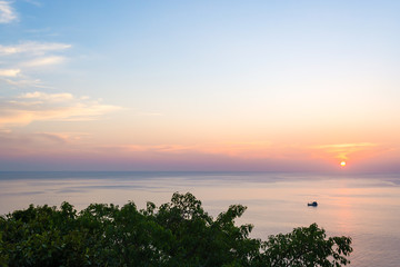 Fototapeta na wymiar Wide angle seascape view of a boat on sunset.