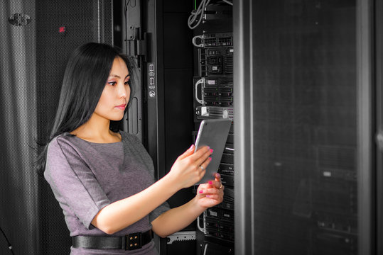 Engineer businesswoman in network server room