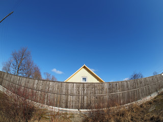 roof of the house over a wooden fence