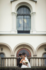 elegant stylish young couple beautiful bride and groom on the stairs