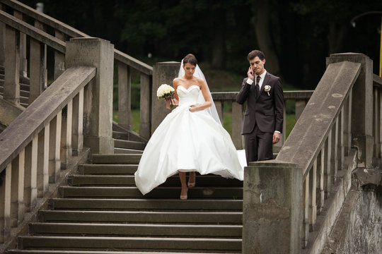 elegant stylish young couple beautiful bride and groom on the stairs