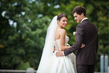 elegant stylish young couple beautiful bride and groom embracing