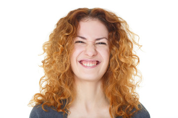 portrait of grimacing girl with curly hair isolated on white background
