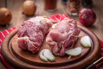 Raw beef roulades prepared for frying.