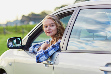 Fototapeta na wymiar Young confident woman driving a car
