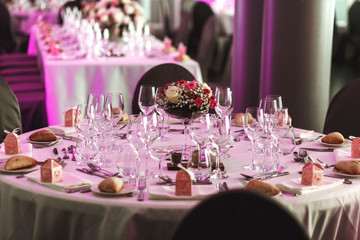 Elegant luxury cutlery and tablewear with flowers at hotel weddi