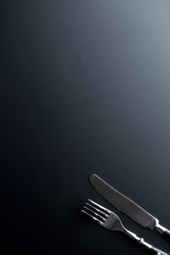 Fork And Knife On Black Background