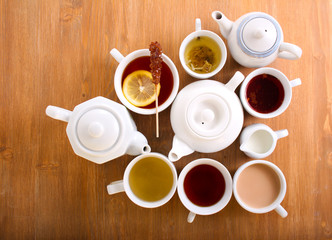 Fototapeta na wymiar Sorts of tea in the cups and tea pots
