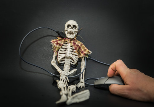 amazing closeup view of human skeleton connected to computer mouse operated by human hand