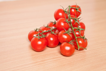 cherry tomatoes on a wooden background close up