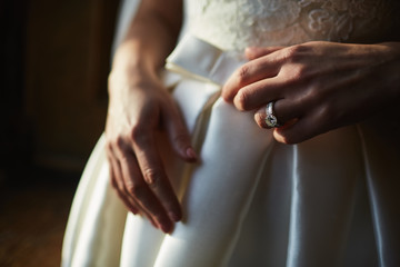 Close up of hands of woman showing the ring with diamond. She is