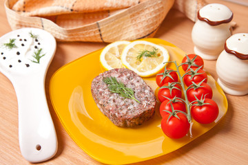 cutlet on a plate with cherry tomatoes