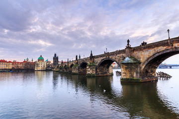 The Charles Bridge (Czech: Karluv Most) is a famous historic bridge that crosses the Vltava river in Prague, Czech Republic