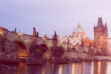 Fototapeta premium The Charles Bridge (Czech: Karluv Most) is a famous historic bridge that crosses the Vltava river in Prague, Czech Republic. Vintage filter applied.