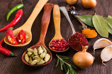 Spices and seasoning on wooden background.