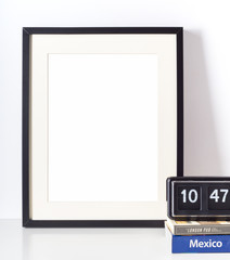 Empty picture frame on white desk