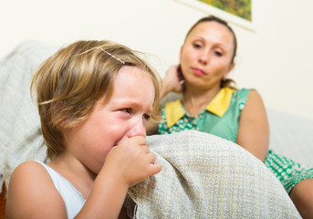 Crying child and mother at home