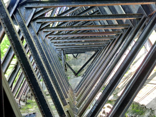 Geometric tunnel of steel metal beams - landscape photo