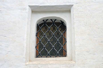 Small window of the ancient building of white color