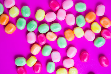 Colorful candy on pink background